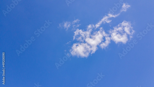 white clouds floating in the blue sky