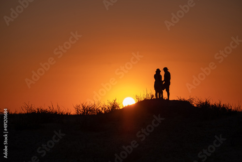 silhouette of a person with sunset background