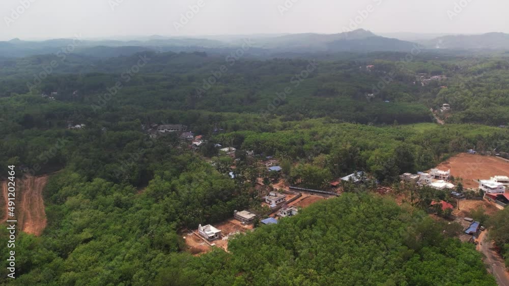 A rural area in south India which is surrounded by hills. Deforestation by houses. A rural area in south India which is surrounded by hills. Deforestation by houses.