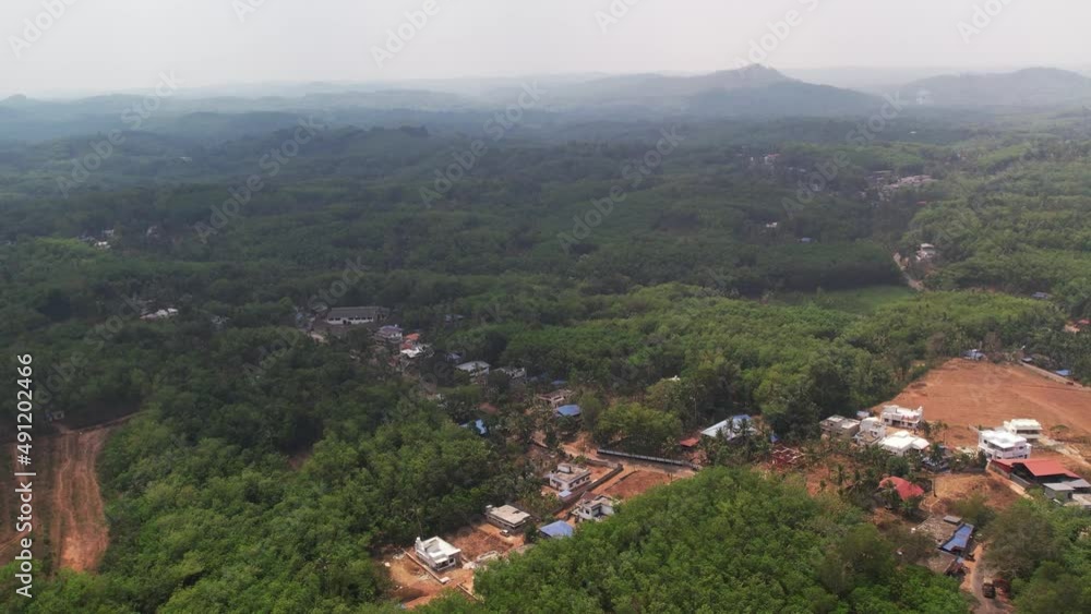 A rural area in Kerala which is surrounded by hills and occupation of houses. A rural area in Kerala which is surrounded by hills and occupation of houses.