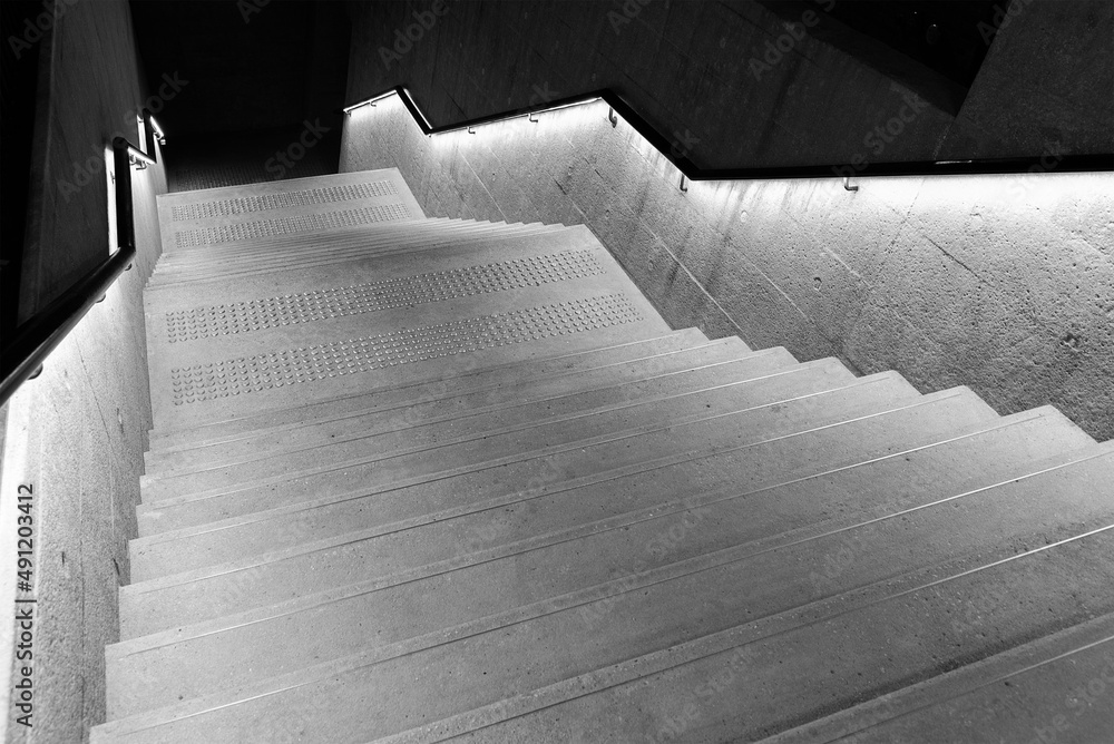Interior view of empty stairway with illuminated bannister in modern architecture