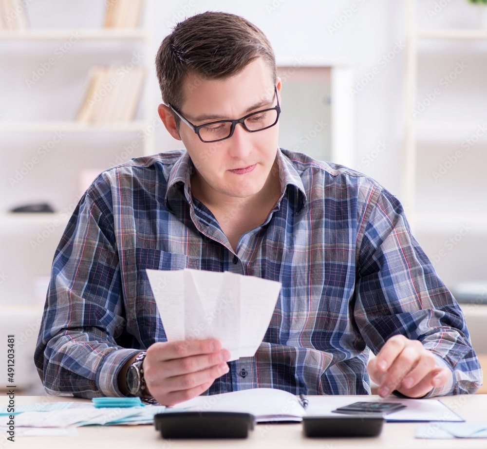 Young man frustrated at his house and tax bills Young man frustrated at his house and tax bills