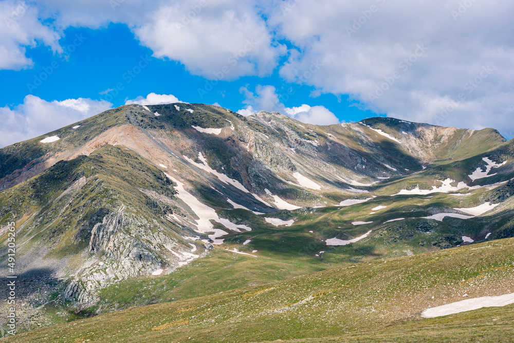 Beautiful landscape in the snow mountains with blue sky and white clouds. (Ulldeter, Pyrenees Mountains)