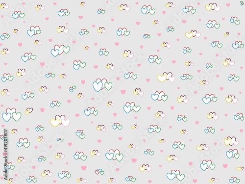 Many colorful hearts of various sizes on a grey background. Valentine day pattern. Wrapping paper design.