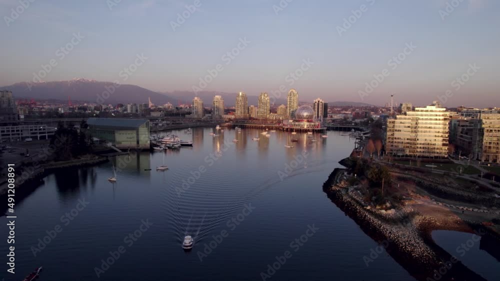 Aerial forward over False Creek at sunset toward Science World building, Vancouver in Canada Aerial forward over False Creek at sunset toward Science World building, Vancouver in Canada