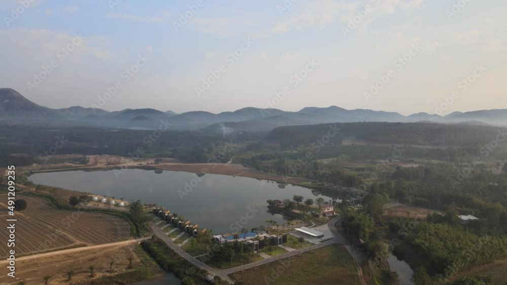 Aerial View of a Lake and Resort with Mountainous Background in Thailand. Aerial View of a Lake and Resort with Mountainous Background in Thailand.