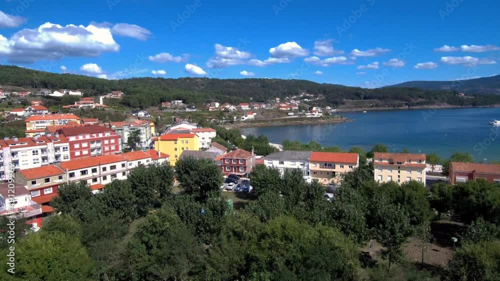 Aerial Rising From Row Of Trees To Reveal Esteiro Town In Spain. Tilt Down Aerial Rising From Row Of Trees To Reveal Esteiro Town In Spain. Tilt Down