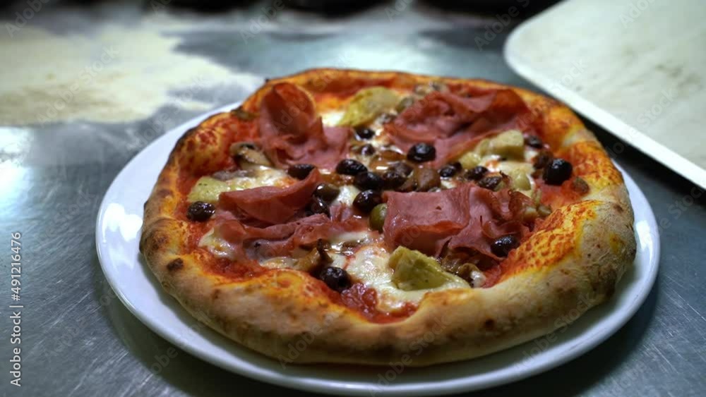 Perfectly good looking freshly cooked delicious pizza on a plate Perfectly good looking freshly cooked delicious pizza on a plate