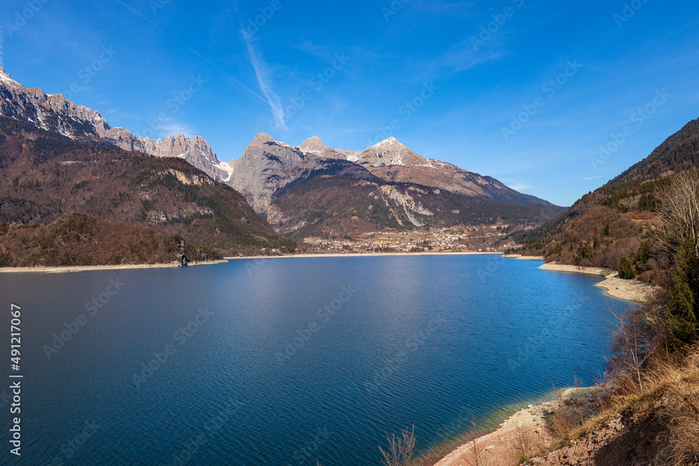Panoramic view of lake Molveno with the Molveno village and mountain range of Brenta Dolomites in winter. National Park of Adamello Brenta. Tourist resort in Trentino Alto Adige, Trento, Italy, Europe