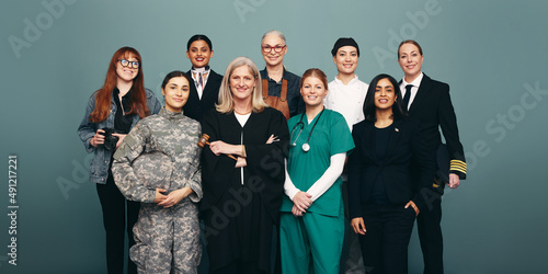 Multicultural female workers smiling in a studio photo