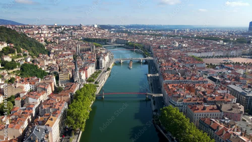 Lyon historical city center and Saône river banks with streets aerial drone video footage. Warm summer day with blue sky. Famous touristic holiday vacation destination in France and Europe. Lyon historical city center and Saône river banks with streets aerial drone video footage. Warm summer day with blue sky. Famous touristic holiday vacation destination in France and Europe.