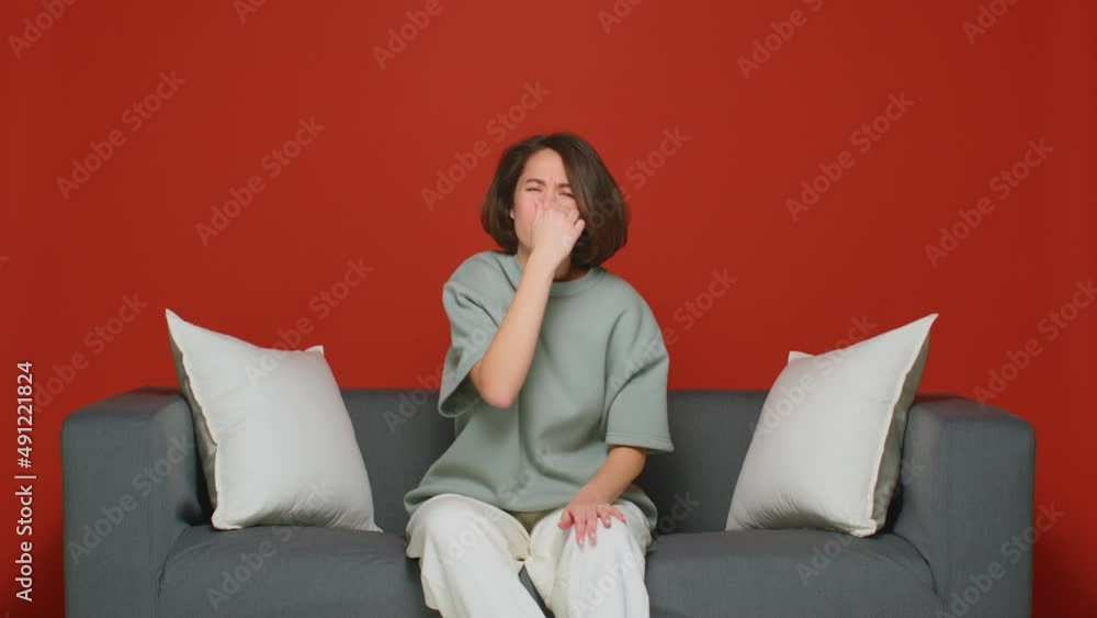 Unpleasant smell. A young woman holds her nose with her hand so as not to feel a strong stench. Unpleasant smell. A young woman holds her nose with her hand so as not to feel a strong stench.