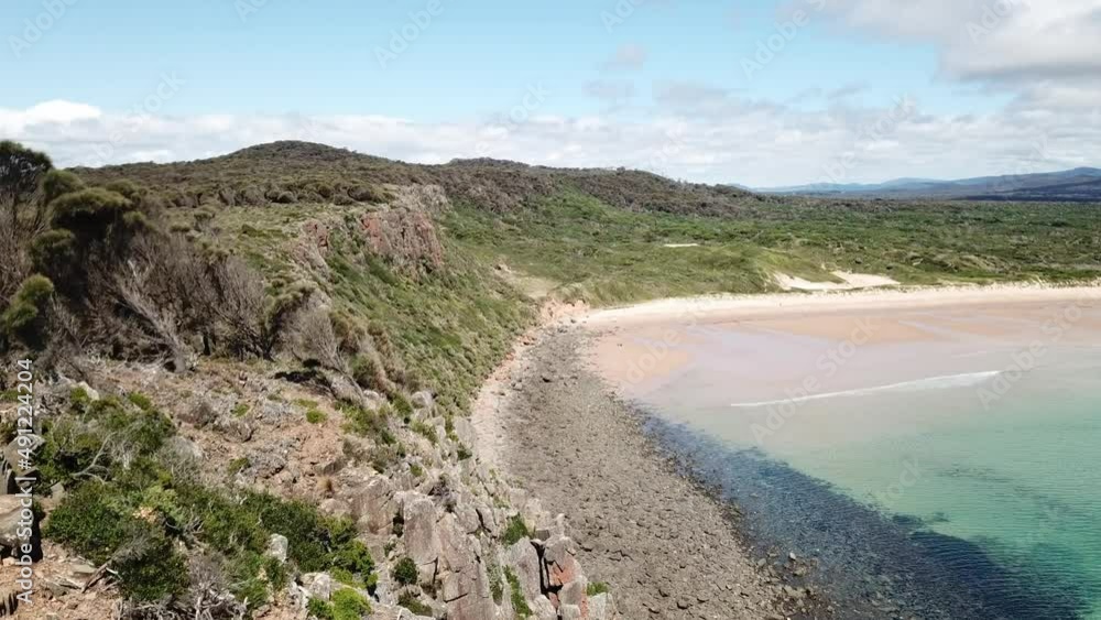 Drone aerial over tropical blue water on sunny day and beach lookout Drone aerial over tropical blue water on sunny day and beach lookout