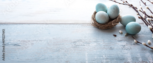 Easter eggs with spring branches on wood
Easter eggs with spring branches on bright vintage wood. Horizontal easter background with space for text.