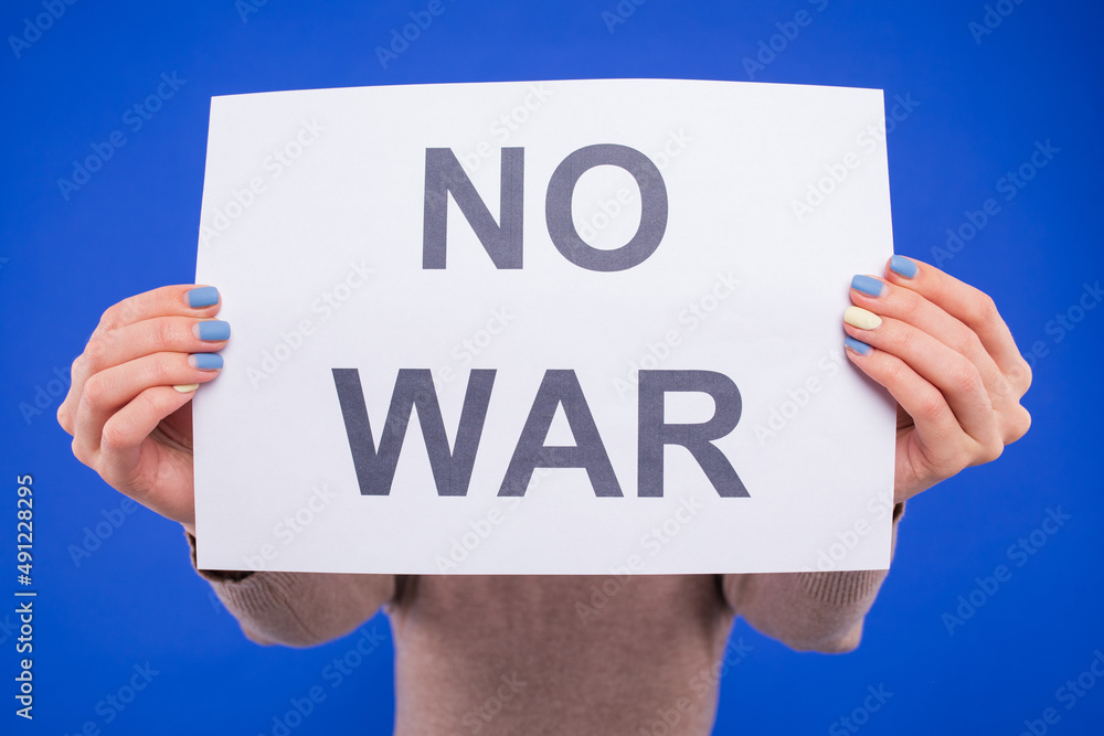 Close-up of the no war poster on a blue background Close-up of the no war poster on a blue background