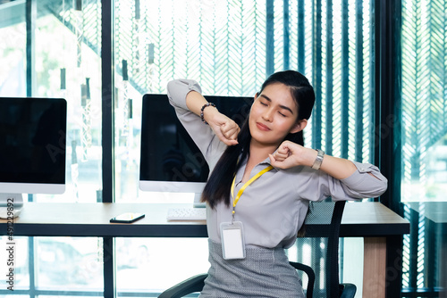 Female office worker arm stretch and body relaxing after work. asian businesswoman stretching body at office table. Free Download Female office worker arm stretch and body relaxing after work. asian businesswoman stretching body at office table. - GFXLoad