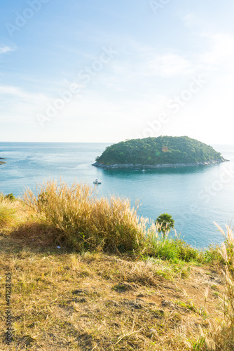 Sunset on Phuket island viewpoint turquoise sea water with yellow grass