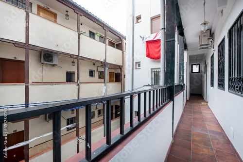 A corrala is a type of housing characteristic of old Madrid, designed as a corridor house with a general wooden frame, they have balconies overlooking an interior patio photo