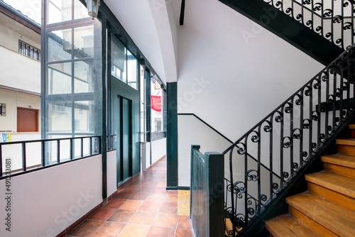Stairs inside a typical Madrid corrala with an elevator attached to a corridor