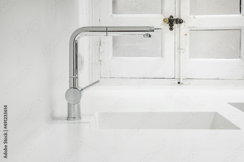 90 degree angle faucet set into a one piece sink with white kitchen countertop 90 degree angle faucet set into a one piece sink with white kitchen countertop