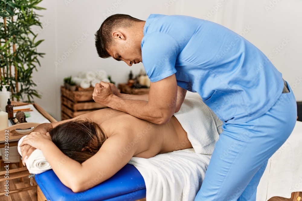 Physiotherapist making massage to woman at beauty center. Physiotherapist making massage to woman at beauty center.