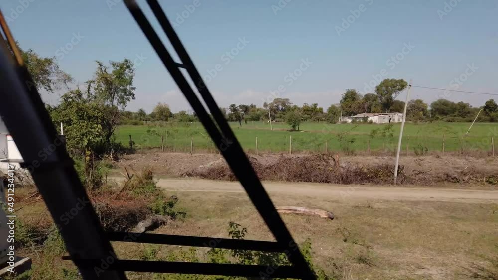 On ride Shot Taken From Moving Indian Train With Open Door In The Countryside Of Rajasthan, India On ride Shot Taken From Moving Indian Train With Open Door In The Countryside Of Rajasthan, India