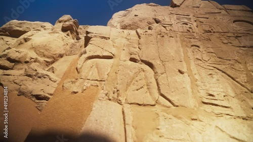 Kings and hieroglyphs carved into rock outside of the Karnak Temple, in Luxor Egypt.
Slow camera movement. photo