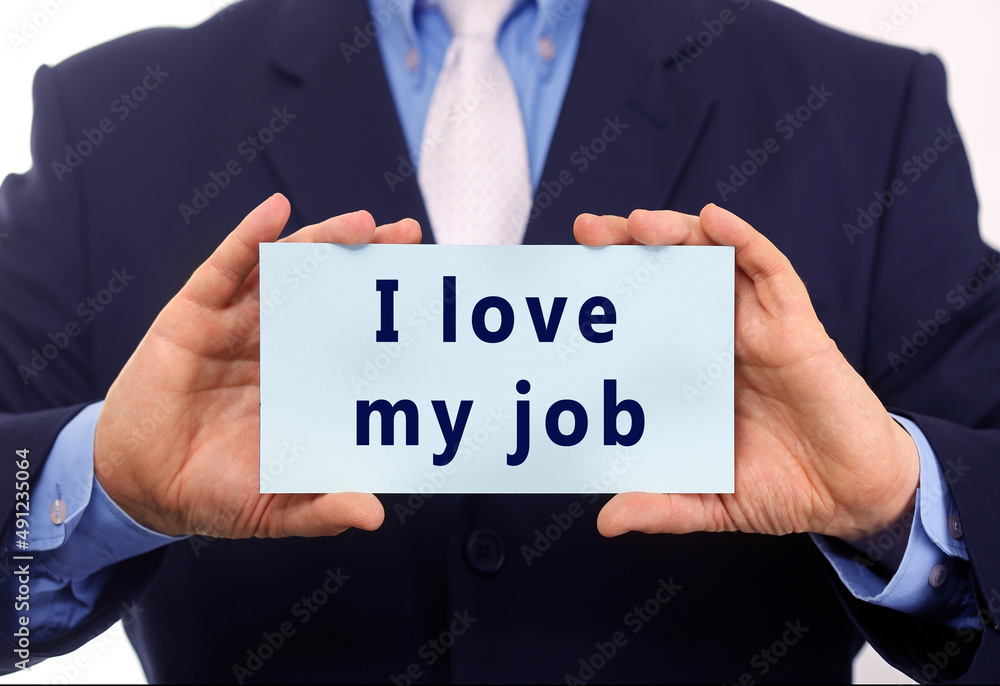 Business man hold paper I love my job text on it Business man hold paper I love my job text on it