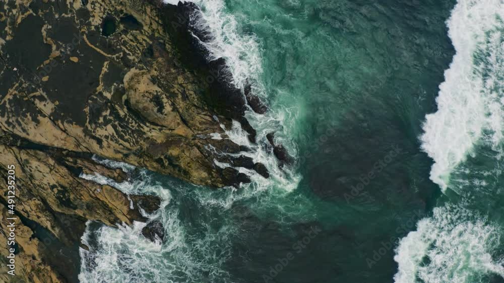 Aerial view above waves hitting cliffs on the coast of Costa Rica - screwdriver, drone shot Aerial view above waves hitting cliffs on the coast of Costa Rica - screwdriver, drone shot