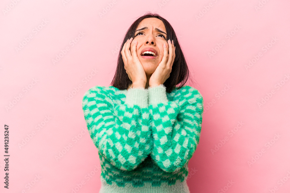 Young hispanic woman isolated on pink background whining and crying disconsolately. Young hispanic woman isolated on pink background whining and crying disconsolately.