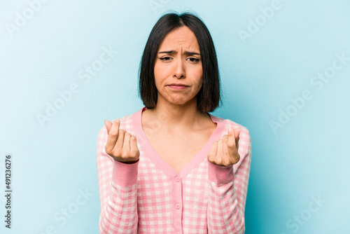 Wallpaper Mural Young hispanic woman isolated on blue background showing that she has no money. Torontodigital.ca