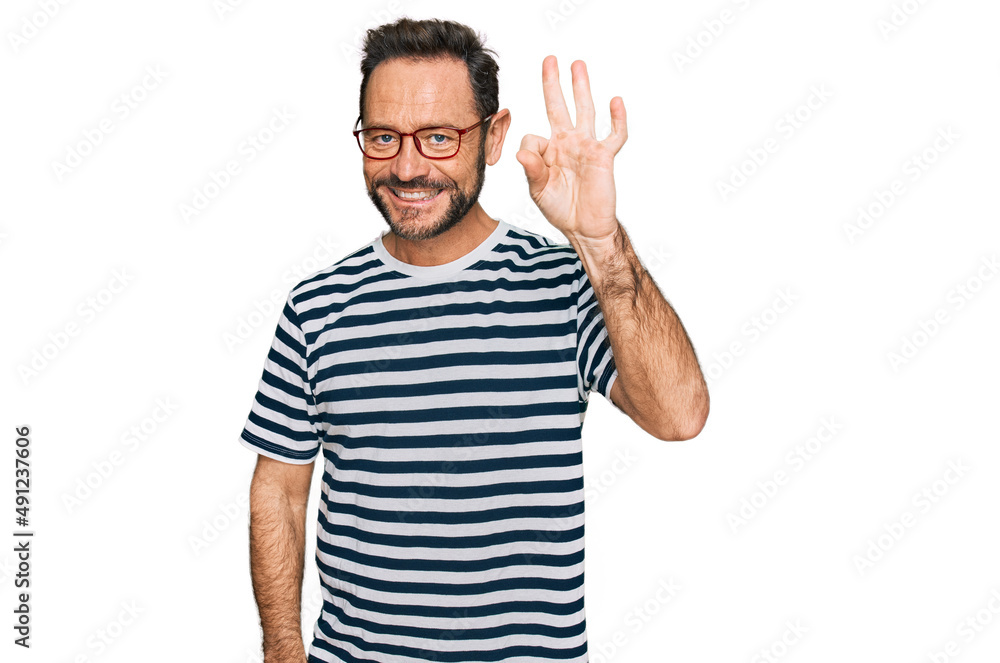 Middle age man wearing casual clothes and glasses smiling positive doing ok sign with hand and fingers. successful expression. Middle age man wearing casual clothes and glasses smiling positive doing ok sign with hand and fingers. successful expression.