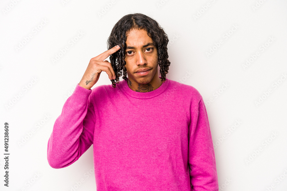 Young African American man isolated on white background pointing temple with finger, thinking, focused on a task. Young African American man isolated on white background pointing temple with finger, thinking, focused on a task.