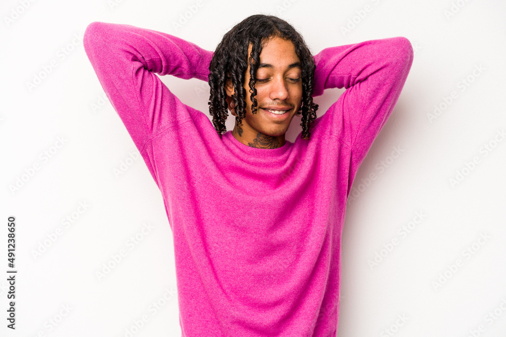 Young African American man isolated on white background feeling confident, with hands behind the head. Young African American man isolated on white background feeling confident, with hands behind the head.