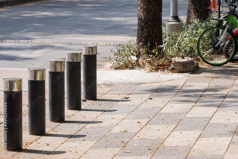 steel bollard on concrete footpath in daytime. steel bollard on concrete footpath in daytime.