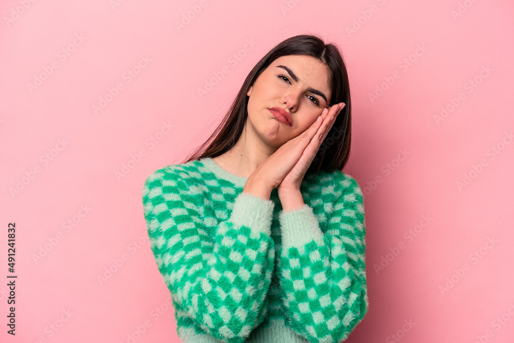 Young caucasian woman isolated on pink background yawning showing a tired gesture covering mouth with hand. Young caucasian woman isolated on pink background yawning showing a tired gesture covering mouth with hand.