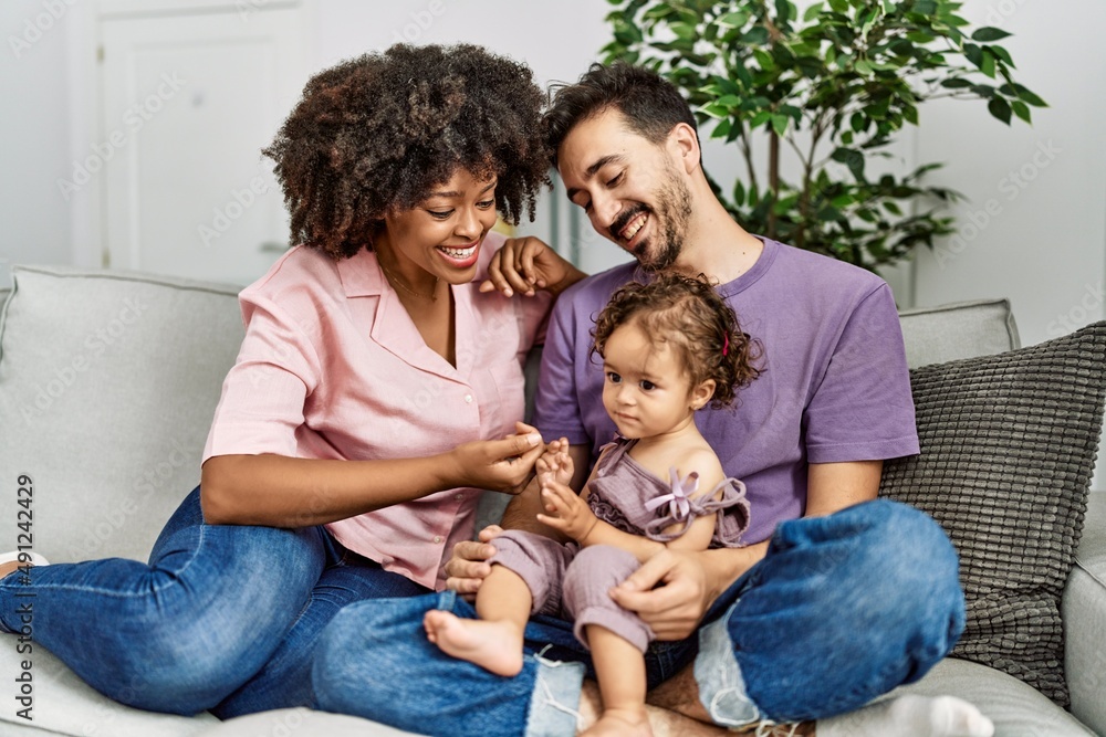Couple and daughter smiling confident sitting on sofa at home Couple and daughter smiling confident sitting on sofa at home