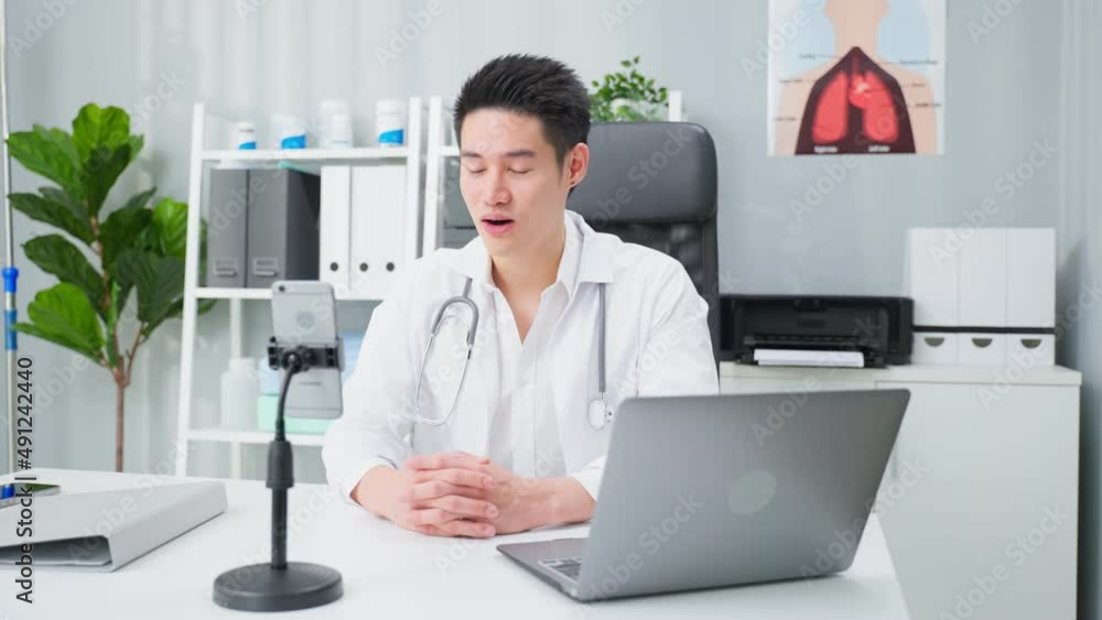Asian male medical doctor talking virtual online with patient at home. Asian male medical doctor talking virtual online with patient at home.