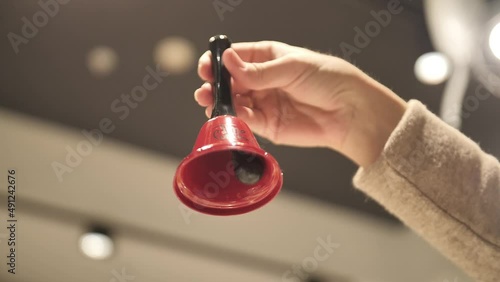 The bell in hand. Ring the red bell.