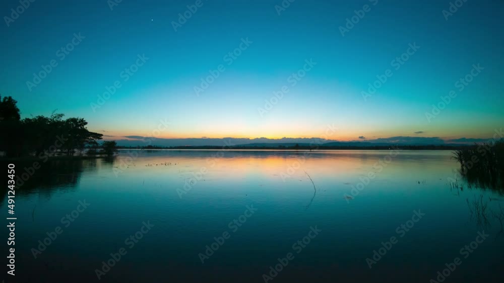 Time lapse video 4K. Nature video High quality footage. Scene of Colorful romantic. Day to night sky sunset over lake with Moving clouds background. time lapse day to night in nature and travel Time lapse video 4K. Nature video High quality footage. Scene of Colorful romantic. Day to night sky sunset over lake with Moving clouds background. time lapse day to night in nature and travel