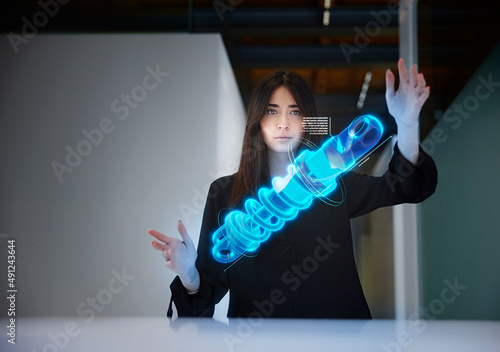 Female engineer analyzing shock absorber in mid-air at office photo