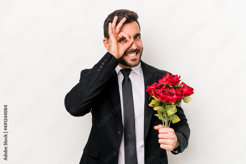Young caucasian man holding a bouquet of flowers isolated on white background excited keeping ok gesture on eye. Young caucasian man holding a bouquet of flowers isolated on white background excited keeping ok gesture on eye.