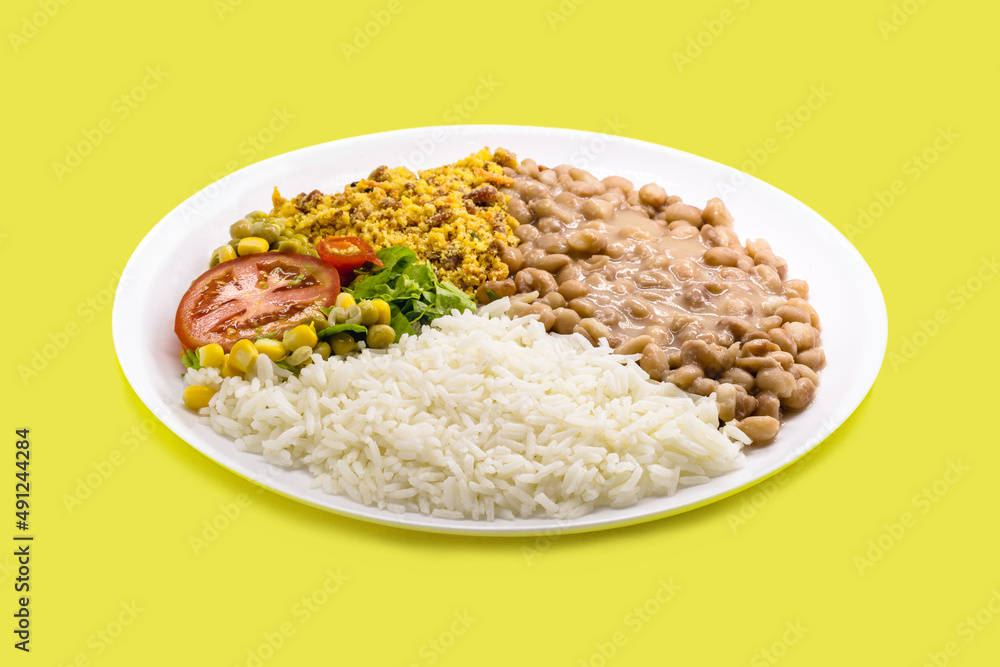 rice and beans dish, chopped tomato salad with corn and peas, on isolated yellow background, traditional brazilian meal rice and beans dish, chopped tomato salad with corn and peas, on isolated yellow background, traditional brazilian meal