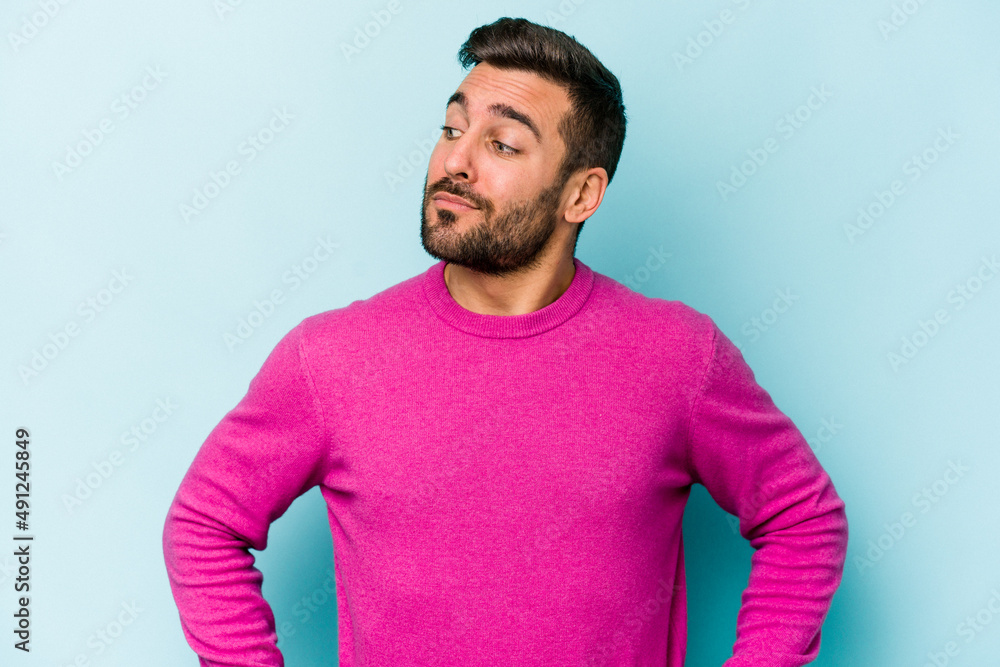 Young caucasian man isolated on blue background dreaming of achieving goals and purposes Young caucasian man isolated on blue background dreaming of achieving goals and purposes