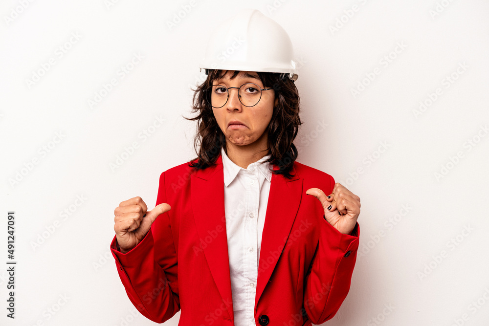 Young architect hispanic woman with helmet isolated on white background feels proud and self confident, example to follow. Young architect hispanic woman with helmet isolated on white background feels proud and self confident, example to follow.