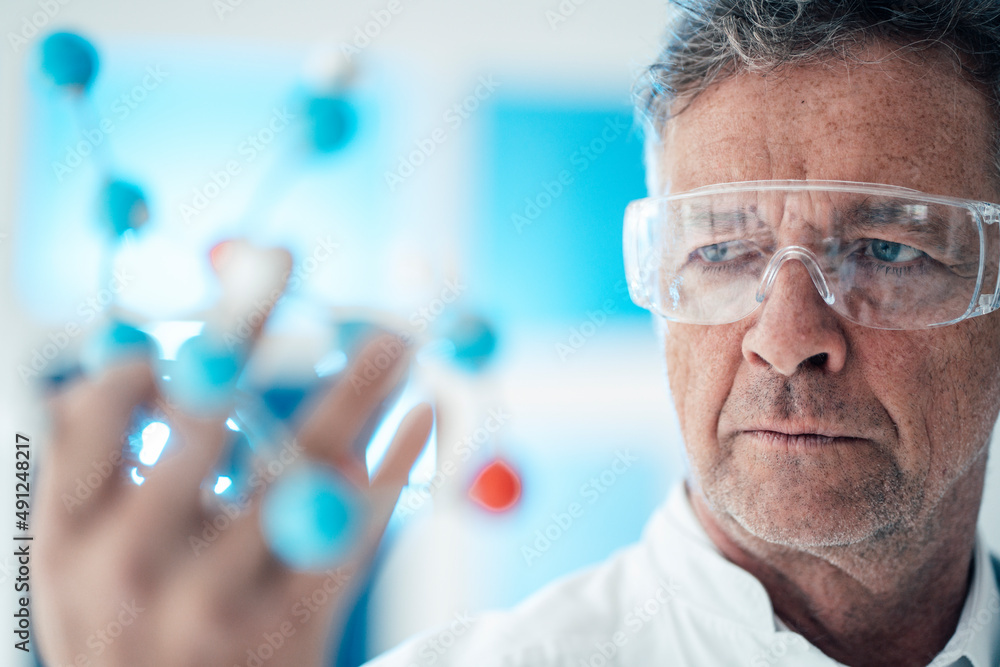 Scientist analyzing molecular structure with protective eyewear Scientist analyzing molecular structure with protective eyewear