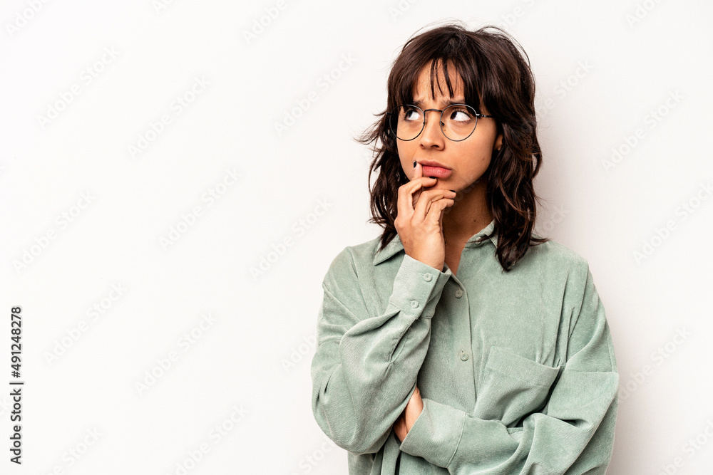 Young hispanic woman isolated on white background looking sideways with doubtful and skeptical expression. Young hispanic woman isolated on white background looking sideways with doubtful and skeptical expression.