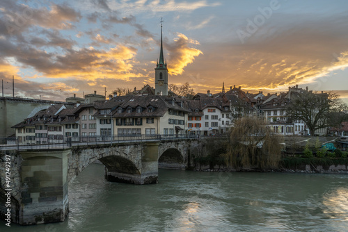 Switzerland, Canton of Bern, Bern, Untertor Bridge at dusk with bell tower of Nydegg Church in background photo
