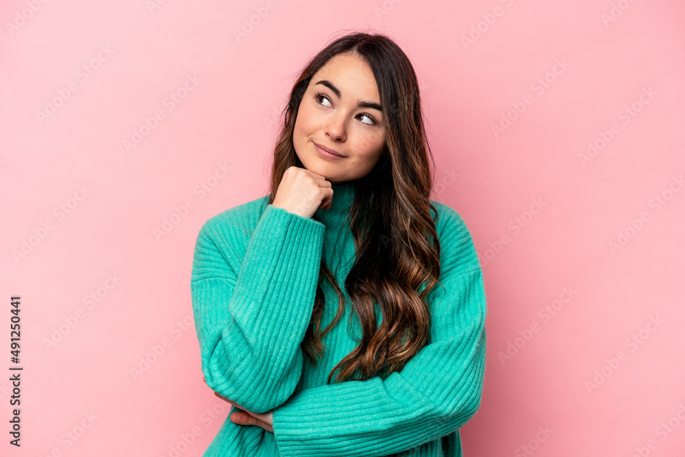 Young caucasian woman isolated on pink background thinking and looking up, being reflective, contemplating, having a fantasy. Young caucasian woman isolated on pink background thinking and looking up, being reflective, contemplating, having a fantasy.