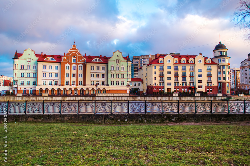 Colored houses on the central embankment at sunset in Kaliningrad.